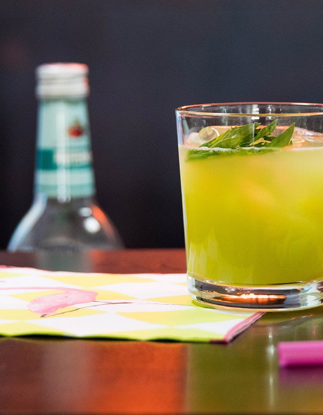 Das Bild zeigt einen grünen Cocktail, der auf einer Theke steht