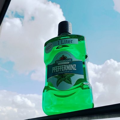 Mundwasser Fanbild 6 Das Bild zeigt eine Mundwasser Flasche vor blauem Himmel.